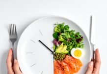 “굶지 말고 시간만 지키세요” 간헐적 단식 16:8 법칙의 놀라운 효과와 실패 없는 실천 가이드 시계 모양으로 나뉜 접시에 건강한 음식이 담겨 간헐적 단식 16:8 시간 법칙을 상징하는 이미지