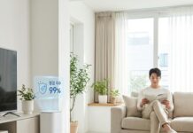 “청소가 저절로 된다고?” 2026년형 셀프 클리닝 홈과 위생 리빙의 혁신 먼지 한 점 없는 세련된 거실에서 로봇 청소기가 스스로 먼지통을 비우는 모습을 흐뭇하게 바라보는 30대 한국인 남성